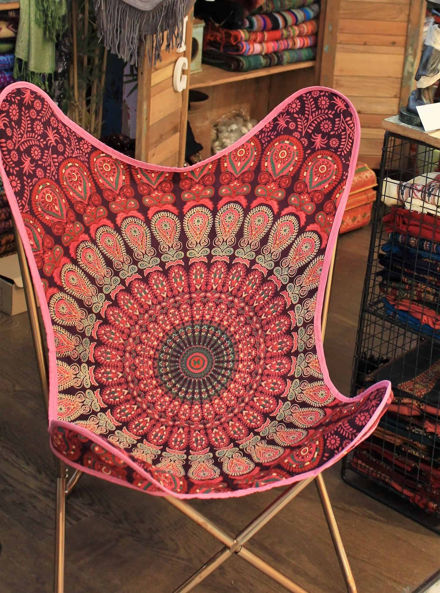A TAPESTRY PRINT BUTTERFLY CHAIR
