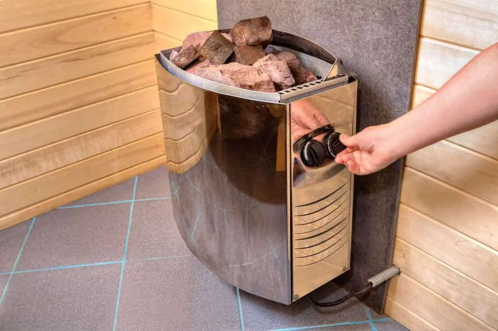 electric-sauna-heater-stove-with-stones-placed-on-top-of-it-5941478